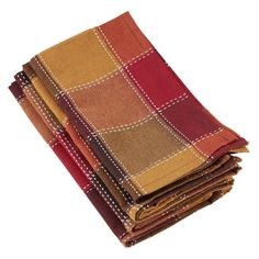 four different colored plaid cloths stacked on top of each other, one red and the other yellow