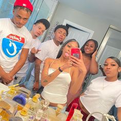 a group of people taking a selfie in front of a mirror