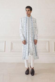 Ivory rawsilk sherwani with aqua blue resham and sequins embroidery Matched with ivory pants and kurta/li> Stole: Aqua blue organza stole with sequins and resham embroidery This is a Four-piece loo White Kurta Men, Ivory Sherwani, Ivory Pants, Blue Sherwani, Resham Embroidery, Blue Organza, Kurta Men, White Kurta