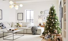 a living room filled with furniture and a christmas tree