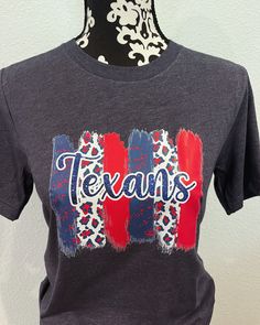 **Welcome to Baby Birds Closet** This listing is for a Texans Game Day shirt! perfect for game day!  Bella Canvas Shirt  Red Navy  or White  ** PLEASE LEAVE IN NOTES** #1 Size needed #2 Color preference for Shirt  #3 Youth or Adult    CARE INSTRUCTIONS This design has been professional heat pressed for the highest quality, and with great attention to details. Please make sure to wash inside out on delicate cycle in cold water, LAY FLAT TO DRY, do not bleach, iron inside out. **PROCESSING AND SHIPPING** Please allow time for your custom item to be made and shipped. If you need your item rushed please contact me prior to ordering.  Thank you for Ordering With Baby Birds Closet Team Spirit Tops For Tailgating With Crew Neck, Team Spirit Crew Neck Top For Tailgating, Tailgating Team Spirit Crew Neck Tops, Sports Fan Short Sleeve Top For Tailgating, Casual Tops With Team Name For Tailgating, Short Sleeve Sports Fan Tops For Tailgating, Team Spirit Tops For Tailgating, Team Spirit Tops With Team Name For Tailgating, Texans Football