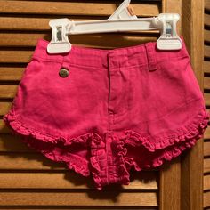 Pink Shorts With Ruffles Around The Bottom, Elastic In The Back, A Rl Metal Tag That Hangs From The Front Belt Loop With A Green Polo Pony Logo Above The Back Pocket. Size 12 Months. 100% Cotton. Nwt Casual Ruffle Bottoms For Playwear, Casual Ruffled Bottoms For Playwear, Pink Short Bottoms For Playwear, Fitted Ralph Lauren Bottoms For Summer, Pink Ruffled Cotton Bottoms, Cute Ruffled Bottoms For Playwear, Fitted Bottoms For Summer Playwear, Fitted Bottoms For Playwear In Summer, Ralph Lauren Cotton Shorts