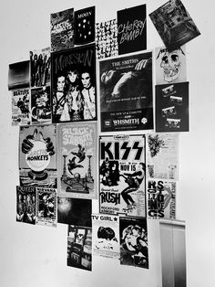 a refrigerator covered in posters and magnets