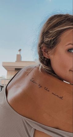 a woman with a tattoo on her back saying i love you to the moon and back