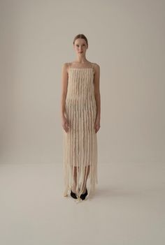 This enchanting Teatralna  dress is a vision of grace, fashioned entirely from 100% silk. Its backless allure adds a hint of sensuality, while the dual layers of silk add depth and texture. The distinctive feature lies in the top layer, composed of vertical stripes that elegantly run longer than the bottom layer, creating a captivating play of length and movement. The arrangement of these strips imparts a unique, modern charm to the gown, making it a standout choice for those seeking a blend of Strips Dress, Gown Making, Design Composition, Timeless Luxury, Stripped Dress, Under Dress, Mid Dresses, Women Artisans, Style Expert