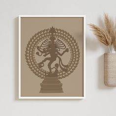 an art print on a wall next to a potted plant and vase with dried grass in it