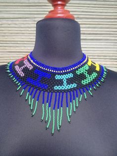 Mexican necklace, Huichol necklance, huchol choker, beaded choker. huichol art. This choker is a piece with a compound made by Huichol artisans, made entirely by hand, unique pieces, very colorful boho type, for any occasion. The Huichol artisans base all their works and their designs on visions they have during their sacred rituals proper to their ethnicity, The Huicholes inhabit the states of Nayarit, Jalisco, Zacatecas and Durango. Piece made by artisans nayaritas. Sent anywhere in the world Colorful Boho Style, Colorful Boho Fashion, Mexican Necklace, Blanket Dress, Mexican Sandals, Vintage Cowboy Boots, Huichol Art, Mexican Dresses, Vintage Cowboy