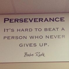 a sign that says it's hard to beat a person who never gives up