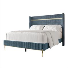 a bed with white sheets and blue upholstered headboard