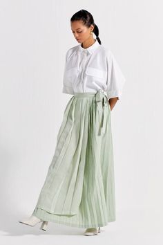 White anti-fit shirt with patch pockets. Comes with mint asymmetric pleated maxi skirt. - Aza Fashions Green Maxi Skirt For Work, Pleated Waist Asymmetrical Skirt For Summer, Summer Asymmetrical Skirt With Pleated Waist, Asymmetrical Skirt With Pleated Waist For Summer, Green Maxi Skirt For Spring Workwear, Chic Pleated Maxi Skirt For Summer, Chic Green Cotton Maxi Skirt, Spring Green Maxi Skirt For Work, Chic Maxi Pleated Skirt For Summer