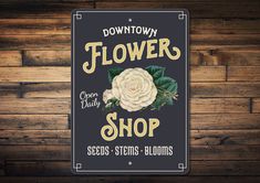 a flower shop sign on a wooden wall