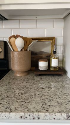 kitchen counter with utensils, soap and other items sitting on top of it