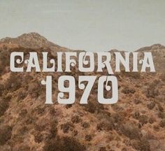 the words california 1970 written in white on top of a mountain