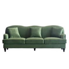 a green couch with four pillows on it's back and one arm folded down