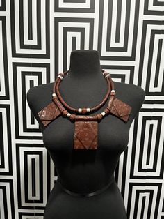 This necklace is crafted with genuine leather from Mali. Unisex and handmade, each piece is one-of-a-kind and may have slight imperfections due to the manufacturing process. Layer it with other necklaces to create a unique look. Traditional Leather Jewelry For Festival, Vintage Leather Necklace As Gift, Vintage Leather Necklace For Gift, Adjustable Leather Pendant Necklace, Bohemian Leather Pendant Necklace, Artisan Brown Leather Necklace, Brown Leather Necklace For Gifts, Brown Leather Pendant Necklace, Traditional Handmade Leather Jewelry