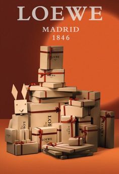 a stack of boxes with red bows on them and the words loewe madrid