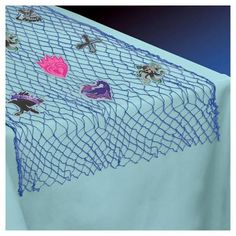 an image of a table cloth with flowers and butterflies on the netted surface in front of a blue background