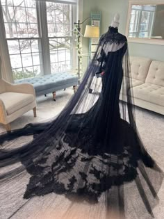 a black wedding gown with long veil on display