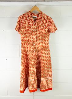 VINTAGE Women's 1960s Fit and Flare Day Dress | Orange Abstract | Unique! Description Australian designed, DOMONY of Sydney, this orange number is slinky and cool, great for Summer! It features buttons from crotch to chest, short sleeves and darts. It does appear that there has been a bit of work done to the seams with some hand sewn alterations/repairs. See pics. Some little holes here and there so it will need a bit of love. Priced accordingly! Material - not labelled Brand - Domony Sydney Siz Orange Fitted Mod Dress, Fitted Orange Mod Dress, Orange Mod Fitted Dress, Retro Orange Summer Dress, Retro Dress With Orange Retro Print, Vintage Orange Summer Dress, Fitted Orange Dress With Retro Print, Orange Retro Dress With Retro Print, Orange Dress With Retro Print