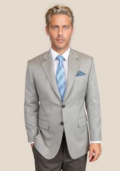 Elevate your wardrobe with our premium Glacier Grey Twill Jacket. Cut from luxurious merino wool by Vitale Barberis Canonico; this custom-made blazer exudes classic style. Neil says "The Glacier Grey Twill was inspired by the serene elegance of winter landscapes. I chose this pure merino wool for its refined twill weave and exceptional softness. It's a fabric that speaks to both formal events and sophisticated business settings, offering timeless versatility and understated charm." Elegant Outerwear With Suit Collar For Semi-formal Occasions, Luxury Tailored Suit, Luxury Tailored Long Sleeve Suit, Elegant Single-breasted Semi-formal Blazer, Elegant Single-breasted Blazer For Semi-formal Occasions, Luxury Fitted Wool Sport Coat, Elegant Wool Tweed Jacket For Business Casual, Elegant Tweed Jacket With Welt Pockets For Winter, Elegant Winter Tweed Jacket With Welt Pockets