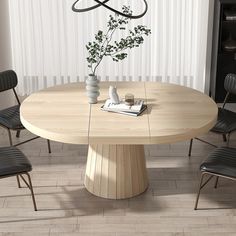 a round wooden table with four chairs around it and a vase on the table next to it