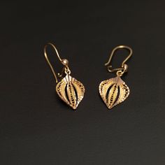 Enhance your style with these elegant and artisan-crafted 14k gold filigree leaf earrings. Each earring features etched solid gold with delicate filigree detailing in between, creating a captivating leaf, fan, or teardrop shape. These exquisite earrings weigh 2.4 grams and showcase meticulous craftsmanship. The leaf-shaped design measures approximately 10.85mm x 7.55mm, with the ear wires included, providing a total length of 21.5mm. Treat yourself or someone special to these unique and versatil Classic 14k Gold Filigree Earrings, 14k Yellow Gold Earrings With Intricate Design, Traditional Rose Gold Filigree Jewelry, Ornate 14k Gold Filigree Earrings, 14k Gold Filigree Earrings, Intricate 14k Gold Drop Earrings, 14k Gold Filigree Earrings For Anniversary, 14k Yellow Gold Leaf-shaped Jewelry, 14k Gold Drop Earrings With Intricate Design