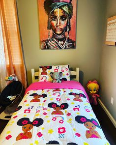 a bed in a bedroom with a painting on the wall above it and stuffed animals