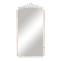 an ornate white framed mirror on a wall