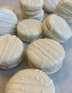 white frosted cookies sitting on top of a table