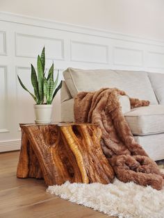 a living room area with a couch, chair and table made out of wooden logs