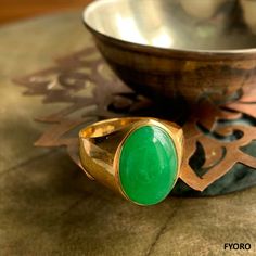 The 'Anyang Royal Jade Ring' symbolizes the ancient Chinese city of Anyang, the birthplace of Chinese civilization 3000 years ago. This beautiful piece symbolizes strength and legacy through its robust and striking design. Materials: 3.75g 14K gold, 0.6g Jade Dimensions: 25.89 x 20.25 x 15 mm Gross Weight: 4.35g Traditional Yellow Gold Emerald Ring, Traditional Yellow Gold Round Emerald Ring, Oval Spiritual Ring With Polished Finish, Oval Spiritual Rings With Polished Finish, Spiritual Hallmarked Signet Ring For Formal Occasions, Spiritual Ceremonial Rings With Polished Finish, Spiritual Gold Emerald Ring, Gold Emerald Ring With Spiritual Style, Spiritual Gold Emerald Ring With Gemstone