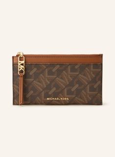 a brown and tan michael kors card case with a gold chain on the front