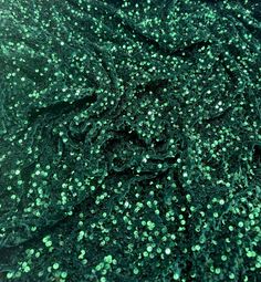 Sequin velvet This beautiful bottle green sequin dress is made from a luxurious velvet fabric that stretches slightly for comfort. The dress is 58 inches wide, equivalent to 147 cm, and is suitable for a range of apparel, upholstery, and craft projects. The dress features a stunning sequin design that adds a touch of glamour to any occasion, making it perfect for weddings, parties, and special events. The fabric is also suitable for creating drapery and upholstery for furniture, as well as beddi Luxury Green Sequin Fabric, Luxury Green Sequin Fabric For Party, Dark Green Sequin Party Dress, Festive Green Sequin Party Dress, Festive Green Sequin Dress For Party, Embellished Green Sequin Fabric, Embellished Green Glamorous Sequin Fabric, Green Glamorous Sequin Fabric For Festive Occasions, Embellished Green Sequin Fabric For Festive Occasions