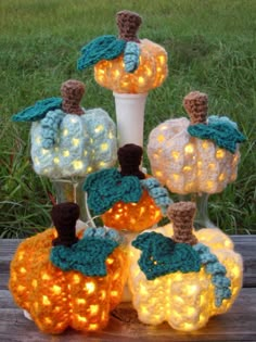 crocheted pumpkins with lights on them