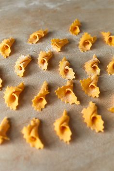 several small pieces of pasta on a baking sheet