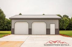 two garages are shown in the middle of a driveway with grass and trees behind them