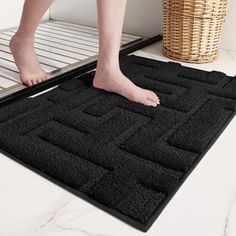 a person standing on top of a bath mat