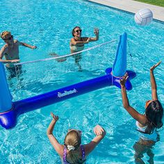 three people playing volleyball in a pool