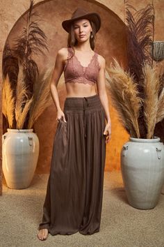 Take your style up a notch with these Peaceful Day Resort Pants. With their wide leg, elastic waist and chic tie front detail, you're sure to proclaim your fashionista status. These brown pants also feature a beautiful satin finish that will make you shine no matter where you go. Slip into these and feel the peace of the day wash over you as you turn heads in every room. Perfect for any occasion, these resort pants are sure to be your go-to when it comes to an effortless style statement. 100% Po Wide Leg Rayon Lounge Pants, Spring Wide Leg Pants With Gathered Waist, Stretch Vacation Bottoms With Tie Waist, Brown High-waisted Harem Pants With Elastic Waistband, Gathered Waist Wide Leg Bottoms, Chic Tie Waist Rayon Bottoms, Chic Rayon Bottoms With Tie Waist, Wide-leg Rayon Harem Pants For Loungewear, Rayon Wide-leg Harem Pants For Loungewear