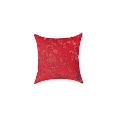 a red pillow with hearts on it