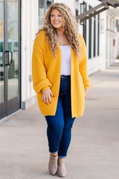 We are so in love with this fabulous cardi! It is the perfect way to add a bold touch to your wardrobe! Crafted from a soft fabric in a vibrant mustard hue, this layering piece pairs effortlessly with a range of looks - from dressed up with a dress and boots to relaxed with a solid top and skinnies! 50% Cotton, 50% Acrylic Solid Cardigan For Day Out In Fall, Solid Cardigan For Fall Day Out, Fall Solid Color Cardigan For Day Out, Chic Fall Cardigan In Solid Color, Chic Solid Color Fall Cardigan, Yellow Sweater For Fall Layering, Yellow Sweater For Layering In Fall, Yellow V-neck Winter Outerwear, Yellow Fall Layering Sweater