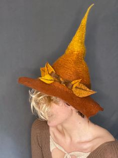 This autumnal witch hat is for the witch in your life who loves the changing of the seasons, or to go the extra mile in your costume this year. The brim has intentional holes to show the wear and tear of a true, age-defying witch. Wet felted for a long lasting, structured feel. Made from 100% merino wool. Perfect for cosplay, everyday witching, dress-up, fashion, or LARPing. Felted Witch Hat, Felted Witch, Felt Witch Hat, Riverside Cottage, Wool Felt Projects, Hat Wool, Wet Felt, Flower Hats, Etsy Products