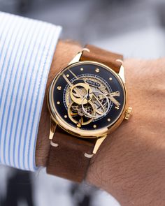 Our exclusive Raketa Skeleton watch is a stunning display of craftsmanship and attention to detail. It features an open skeleton design, revealing the intricate workings of the movement underneath.  The dial is adorned with gold-toned embellishments, including finely engraved patterns and gear wheels, creating a stunning visual contrast against the silver tones of the movement. The hour and minute hands are also gold-toned, adding to the overall elegance of the watch.  The watch is complemented by a stylish and durable leather strap, providing both comfort and a sophisticated look.  Year: 1980's  Case size: 39 mm  Case material: Steel Strap material: Leather  Movement: Mechanical Raketa cal. 2609 FEEL FREE TO ASK ANY QUESTIONS ABOUT THE WATCH BEFORE PURCHASE! I will be happy to answer any Watch Gift For Him, Watch Gift Box, Gear Wheels, Skeleton Design, Retro Watches, Watch Gift, Authentic Watches, Skeleton Watch, Wristwatch Men