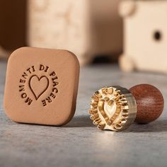 a rubber stamp with a heart on it next to a wooden ring and some other items