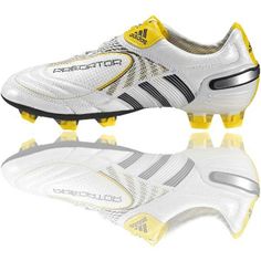 a white soccer shoe with yellow accents