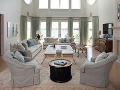 a living room filled with furniture and windows