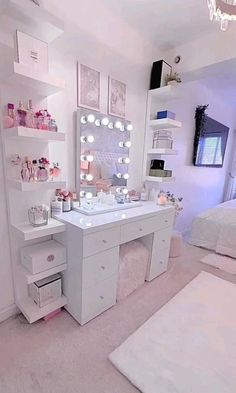 a white vanity with lights on it in a bedroom