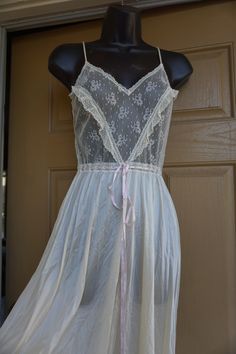 "White maxi nightgown by La Femme De Vanity Fair. No size labeled - estimated small. In good vintage condition. Measurements taken across front laid flat 18\" across front armpit to armpit 14\" across waist 52\" length" Feminine Fitted Nightgown For Home, Sheer White Nightgown For Sleepovers, White Sheer Nightgown For Sleepover, Vintage Sheer Sleepwear For Sleepover, Vintage Sleepwear With Lace Trim, Vintage Nightgown For Wedding Night, White Bias Cut Nightgown For Sleep, Vintage Lace Trim Dresses For Loungewear, Vintage Sheer Nightgown For Sleep