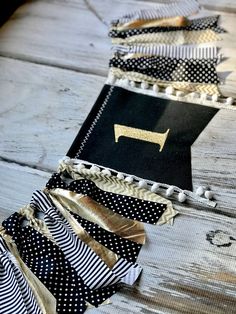 black and white striped fabric with gold foil on it sitting on top of a wooden table