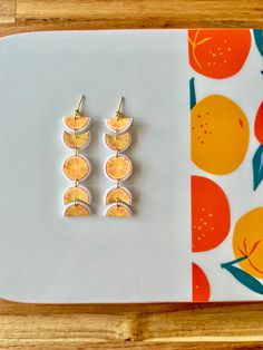 three orange slices are placed on top of each other in front of a white plate